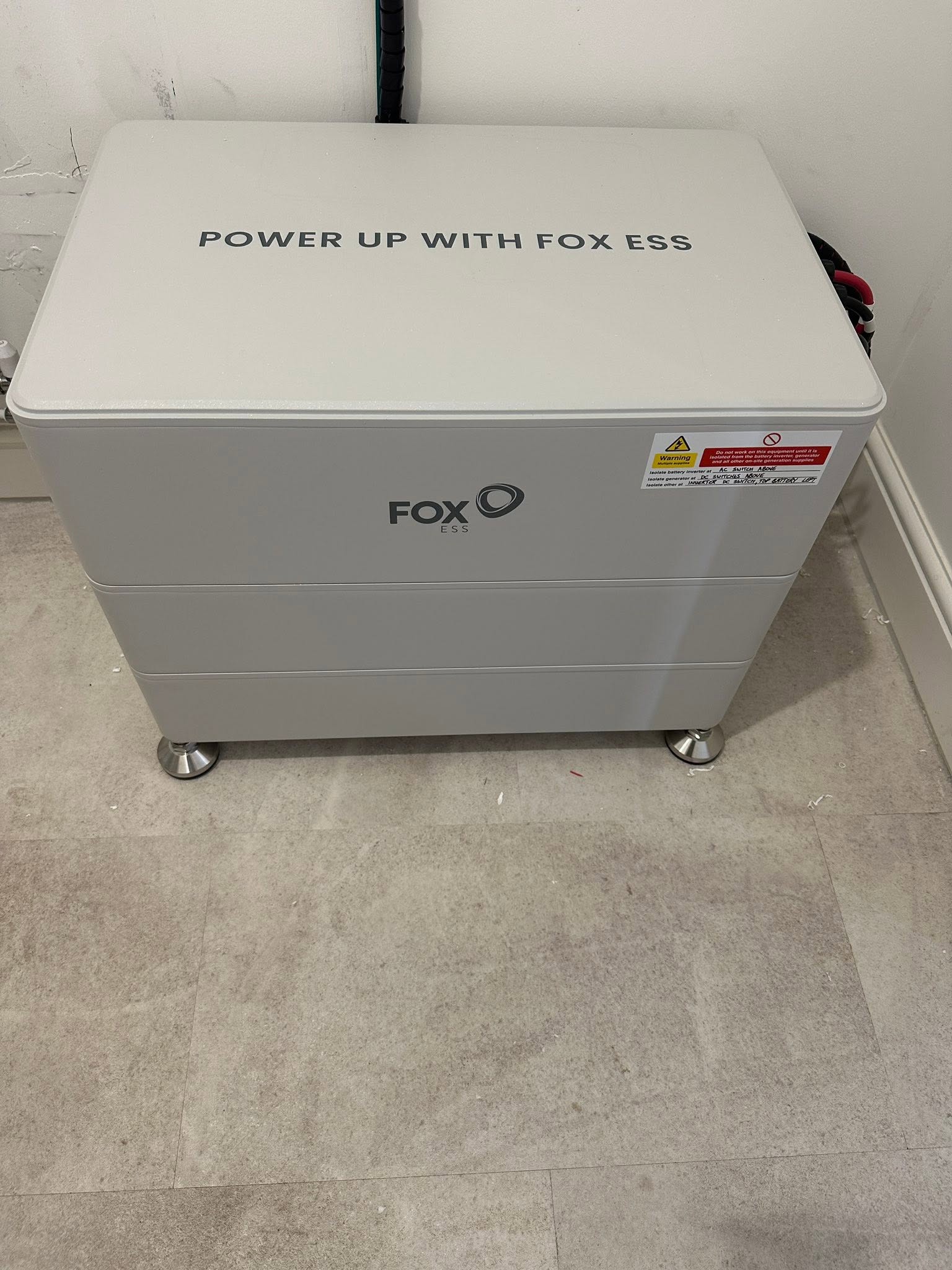 A Fox ESS battery unit standing on a floor