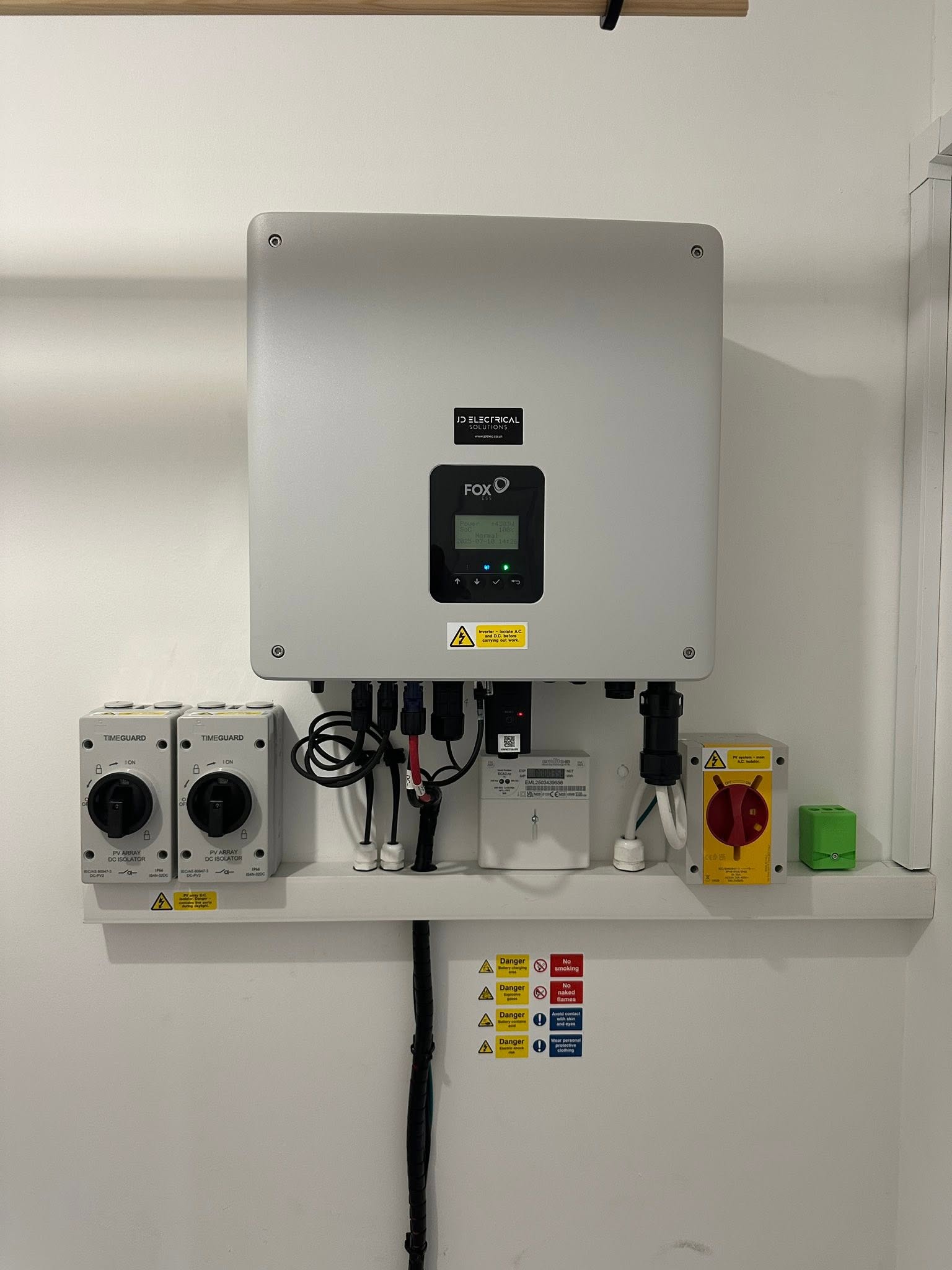 A hybrid inverter and isolators installed on an inside wall